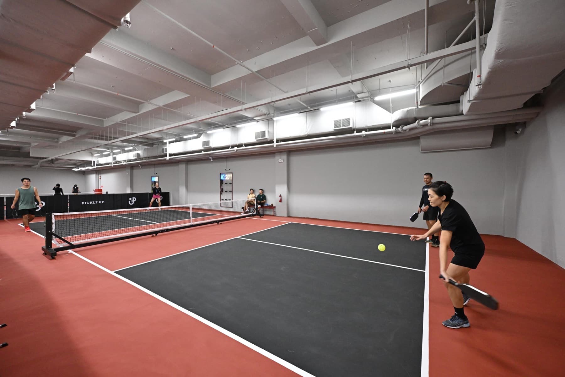 Court 4, a Signature court, with players at the far end.