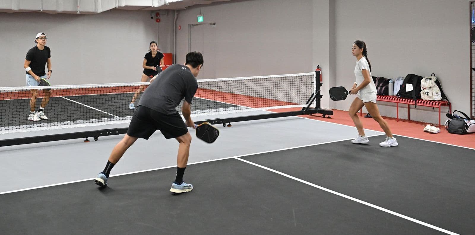 Doubles on an Executive court, with the paddle wall behind the far baseline.
