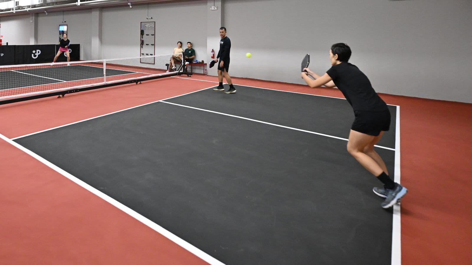 A player stretching for a forehand on a Signature court.