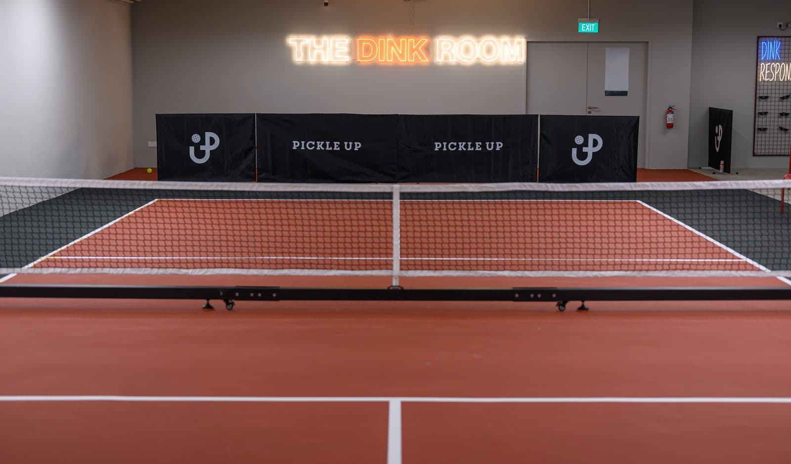 The Dink Room: a private court under its glowing neon sign.